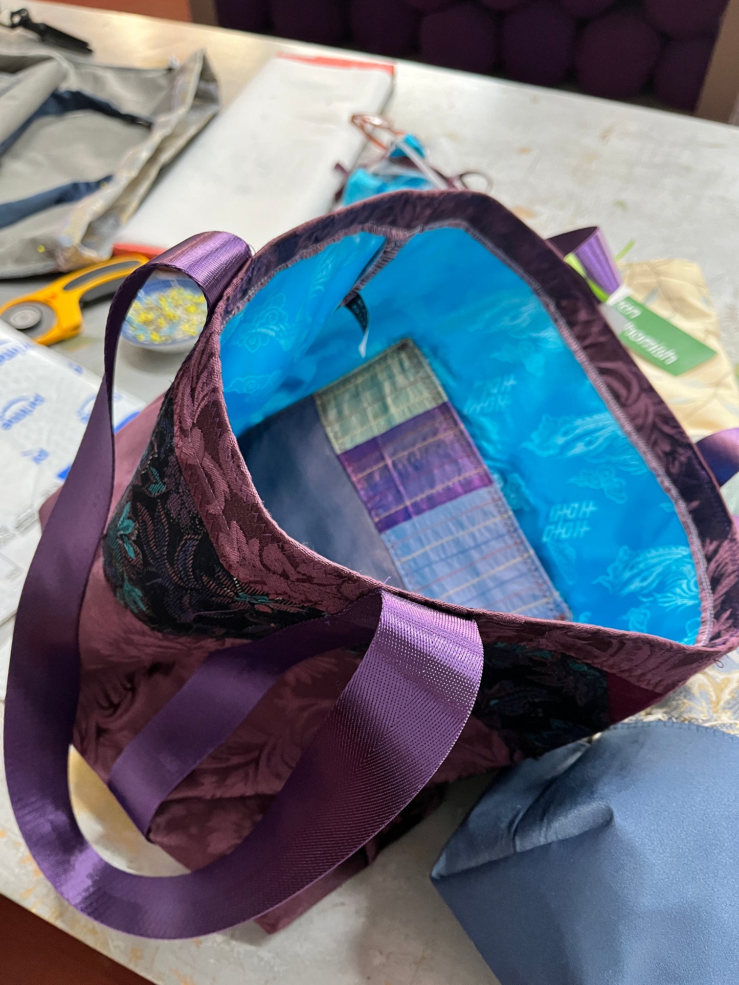 luscious purples shine with a brocade strip, and a bright turquoise silk lining.